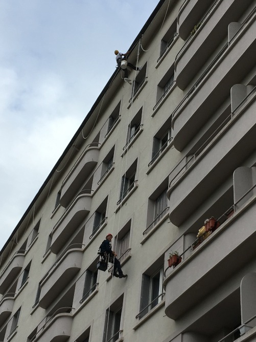 Cordistes au travail sur la façade d'un immeuble